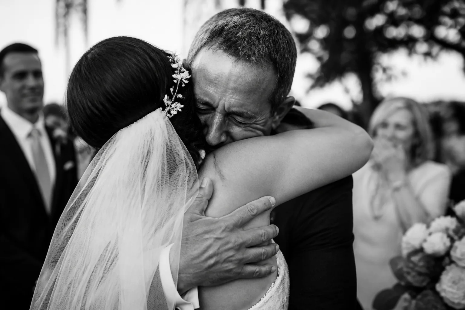Emotional black-and-white wedding photograph emphasizing expression and gesture